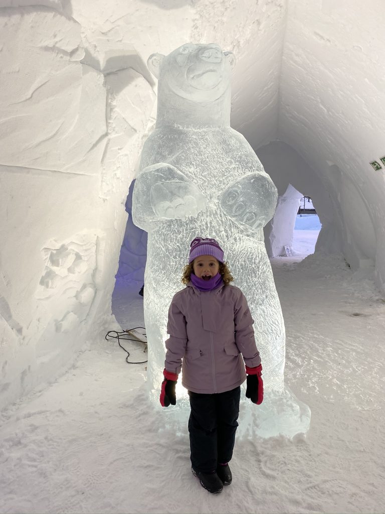 girl standing in front of ice bear