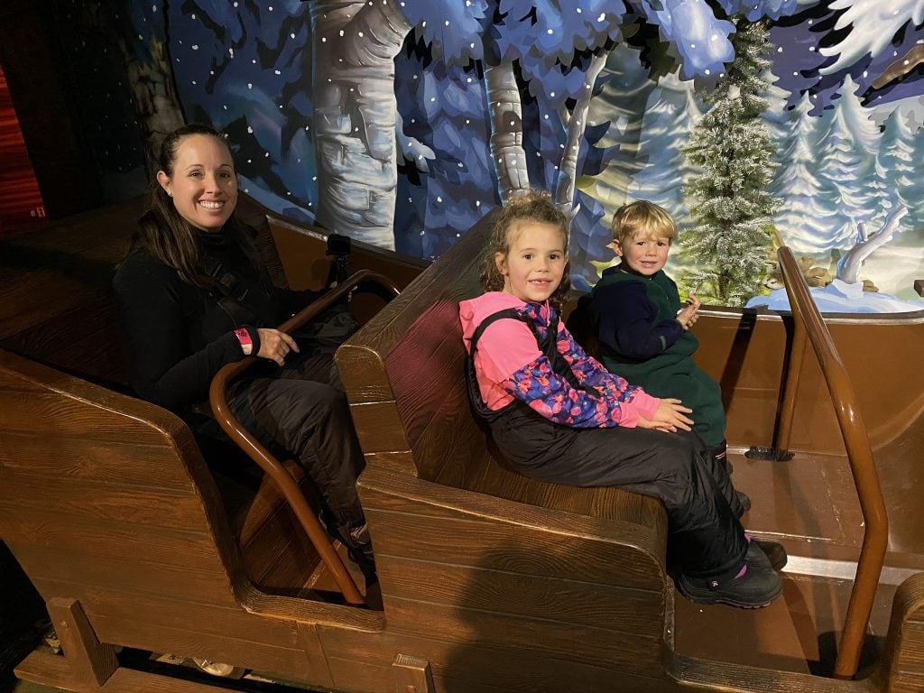 family riding magic train ride at Santa Park